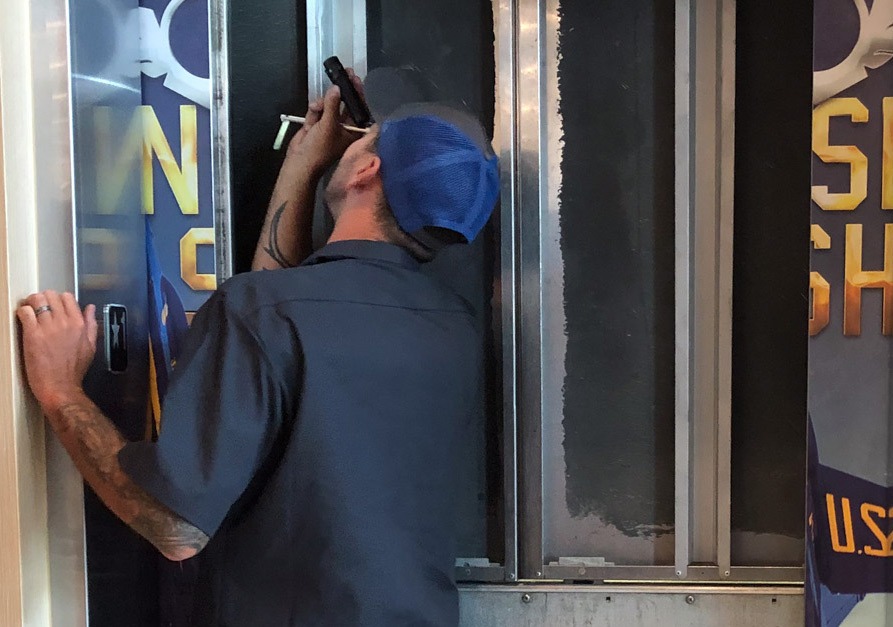 A technician inspecting an elevator